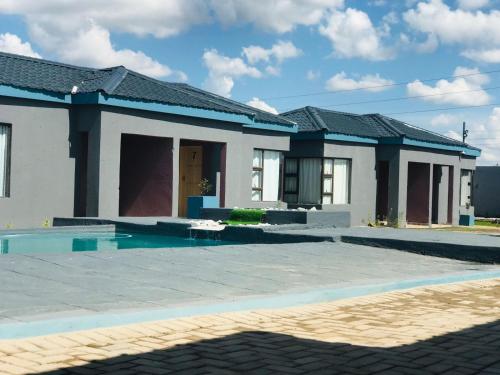 a house with a swimming pool in front of it at RMB Luxury Lodge in Ga-Mothiba