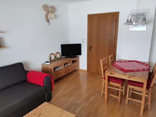 a living room with a couch and a table at Landhaus Marie in Hermagor