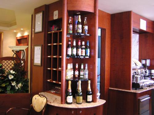a shelf with bottles of wine in a bar at Hotel Mistral in Portoscuso