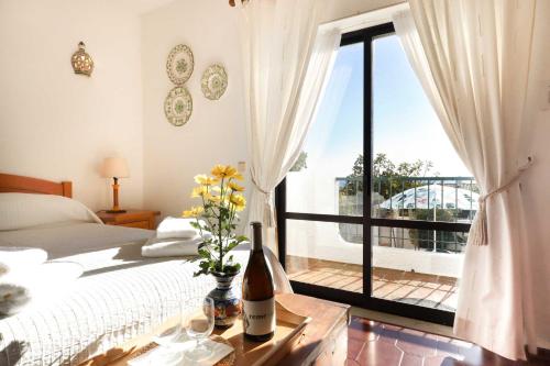 a bedroom with a bed and a large window at 3B Waterside in Luz