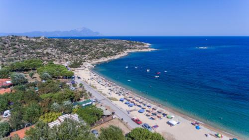 an aerial view of a beach with umbrellas and the ocean at ViLLA DRAGANI in Sikia