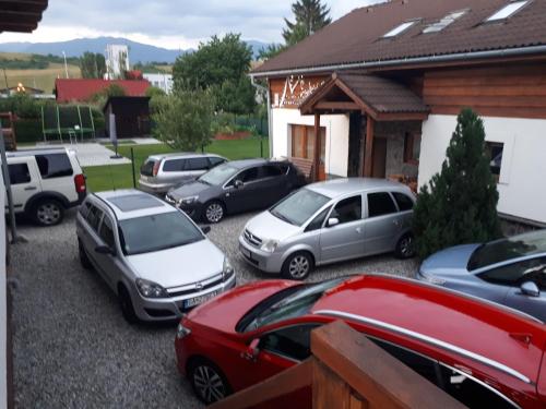 a group of cars parked in front of a house at Privat Mrzkan in Liptovský Mikuláš