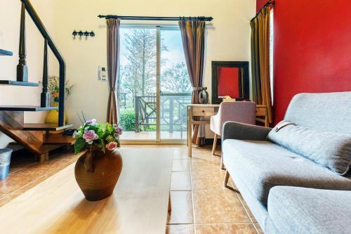 a living room with a couch and a vase of flowers at Bali Lover in Ji'an