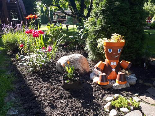 a garden with a statue of a pot of flowers at Privat Mrzkan in Liptovský Mikuláš