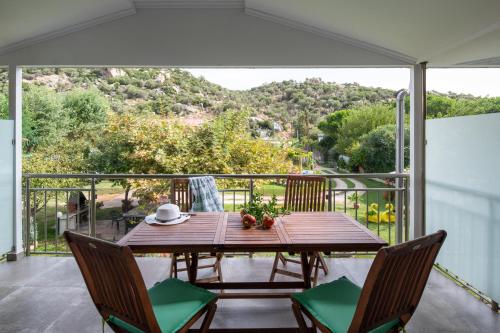 a table and chairs on a balcony with a view at ViLLA DRAGANI in Sikia