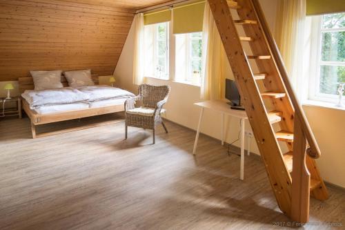 a bedroom with a bed and a staircase and a desk at Ferienhaus Viebrock 