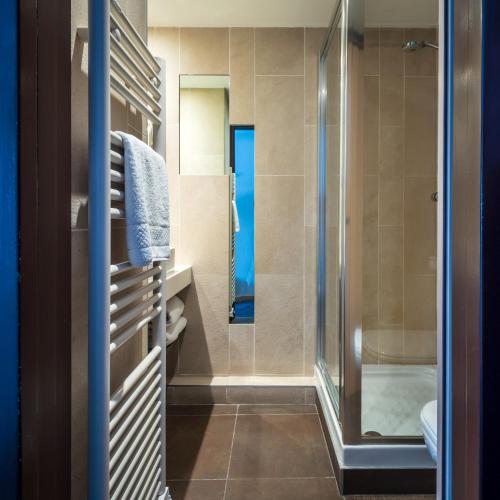 a bathroom with a shower and a toilet at Hôtel de Bonlieu in Annecy