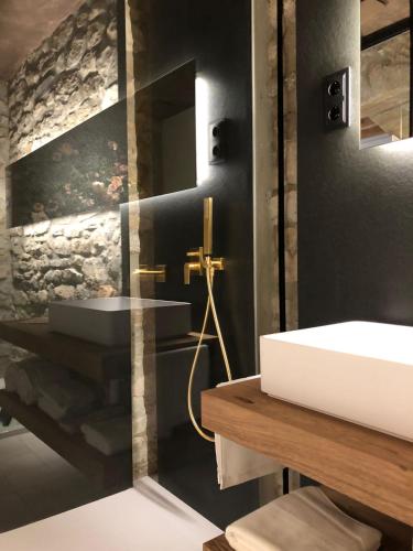 a bathroom with a white sink and a mirror at Les Quingles in Calders