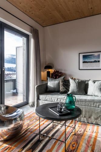 a living room with a couch and a table at Pförtner Penthouse in Hausham