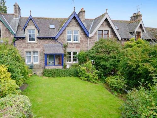 a large brick house with a large yard at Andreu Cottage in Callander