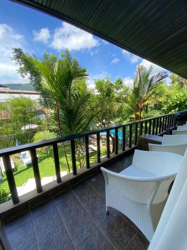 a balcony with chairs and a view of the ocean at Lokal Phuket "Former K-Hotel" - SHA Extra Plus in Patong Beach