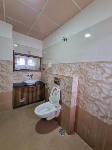 a bathroom with a toilet and a sink at The Urban Nest in Bangalore