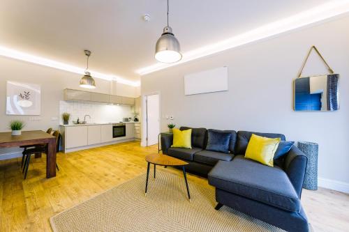 a living room with a blue couch and a table at One Bedroom Apartments in Gloucester road north in Bristol