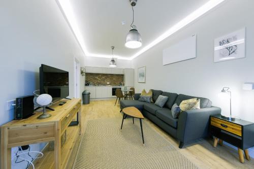 a living room with a couch and a table at One Bedroom Apartments in Gloucester road north in Bristol