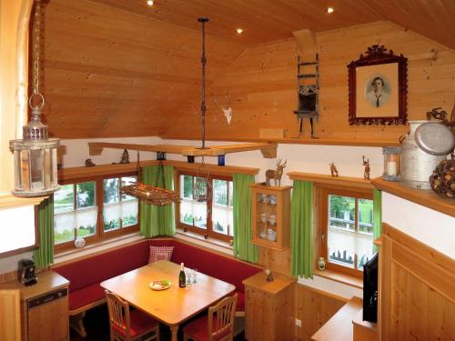 a kitchen with a table and some windows at Holiday Home Landhaus Hubner by Interhome in Gröbming