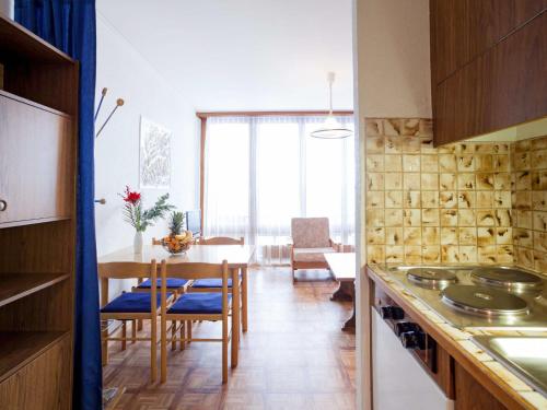 a kitchen with a table and a dining room at Studio Résidence Greppon by Interhome in Les Collons
