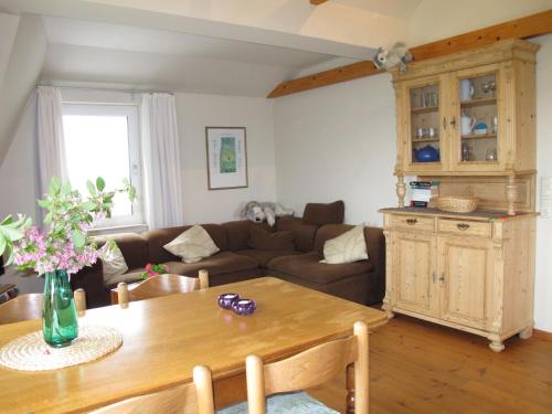 a living room with a couch and a table at Apartment Landhaus Mahnhamm-2 by Interhome in Wiarden