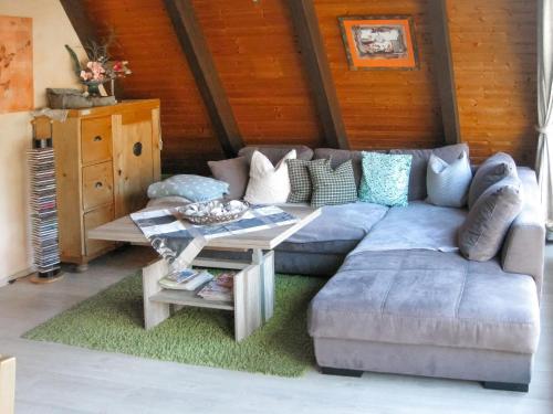 a living room with a couch and a table at Holiday Home Winnetou by Interhome in Machtlos