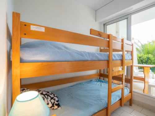 a couple of bunk beds in a room with a window at Studio Ulysse Plage-4 by Interhome in La Grande Motte