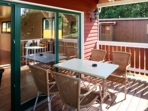 a patio with a table and chairs on a deck at Holiday Home Erzeberg-3 by Interhome in Balhorn