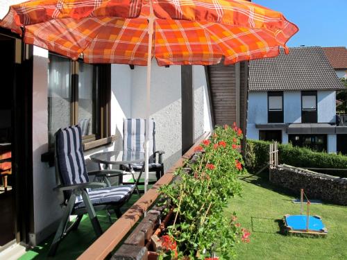 a patio with a table and chairs and an umbrella at Apartment Wartbuck by Interhome in Ühlingen-Birkendorf