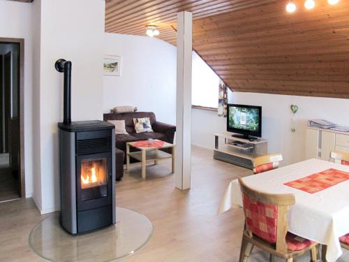 a living room with a wood stove in a room at Apartment Wartbuck by Interhome in Ühlingen-Birkendorf