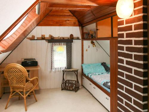 a small room with a bed and a desk at Chalet Jiri - DEH110 by Interhome in Žabovřesky