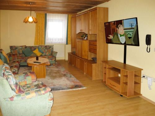 a living room with a couch and a flat screen tv at Apartment Irene by Interhome in Lohberg