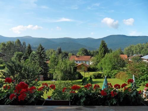 a garden with flowers and mountains in the background at Apartment Irene by Interhome in Lohberg