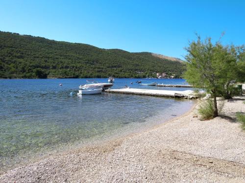 a boat is docked at a dock on a lake at Apartment Perisa by Interhome in Grebaštica