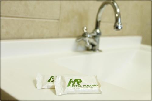 a tube of toothpaste sitting on a bathroom sink at Hotel Paranoa in Jaboticabal