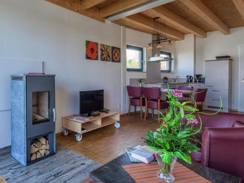 a living room with a couch and a fireplace at Holiday Home Hafenhaus by Interhome in Großpösna