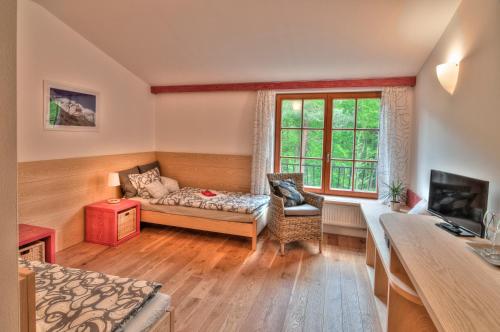 a living room with a couch and a window at Statek Samsara in Blansko