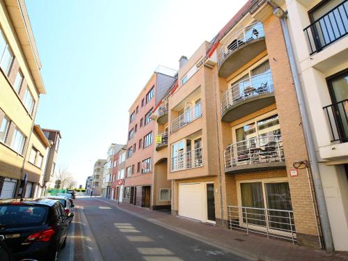 a city street with buildings and cars parked on the street at Apartment Residentie Irena app-302 by Interhome in Bredene
