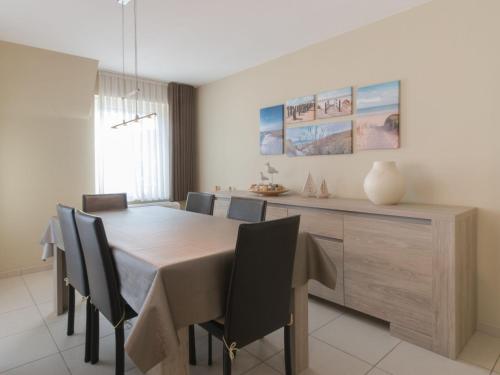 a dining room with a table and chairs at Apartment Residentie Irena app-302 by Interhome in Bredene