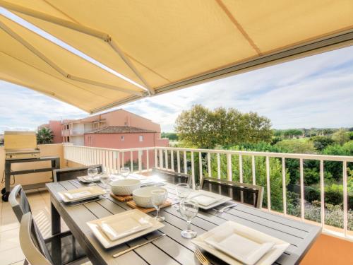 a dining table on the balcony of a house at Apartment Bella Vista by Interhome in Cap d'Agde