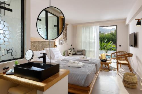 a bedroom with a bed and a mirror and a sink at Bali Star Resort Hotel in Balíon