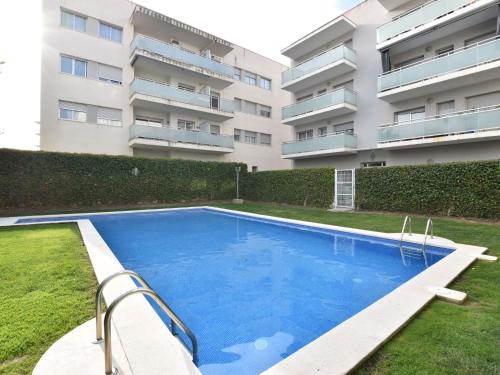 a swimming pool in front of a building at Apartment Oliveres by Interhome in Torredembarra