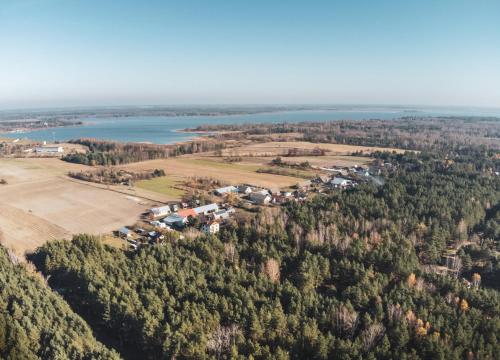 an aerial view of a farm and a lake at Leśna 21 Dom Południe przy PUSZCZA BIAŁOWIESKA in Łuka