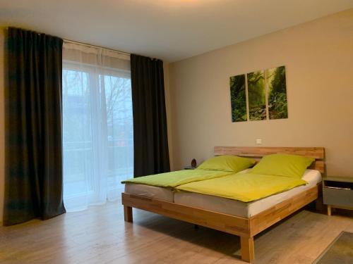 1 dormitorio con cama y ventana grande en 2nd Home Appartements 23, en Nieder-Olm