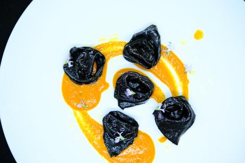 a plate with a face made out of an orange at L'Antico Uliveto in Porto Potenza Picena