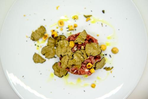 a white plate with some food on it at L'Antico Uliveto in Porto Potenza Picena