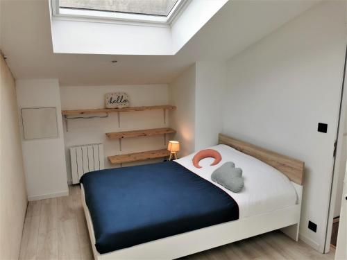 a bedroom with a bed and a skylight at Ancienne sous-prefecture in Les Sables-dʼOlonne