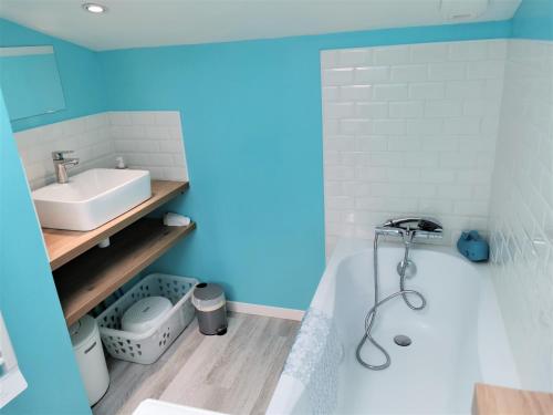 a bathroom with a white tub and a sink at Ancienne sous-prefecture in Les Sables-dʼOlonne