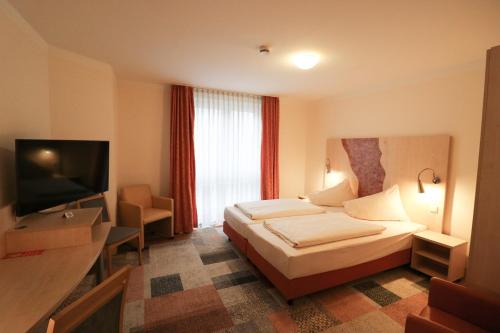 Een bed of bedden in een kamer bij Petul Apart Hotel Ernestine