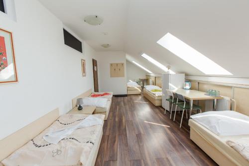 a room with beds and a table in it at Penzion Hviezda in Bratislava
