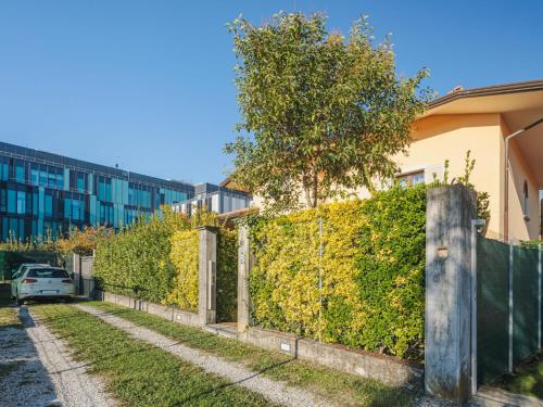 a hedge in front of a building with a fence at Apartment Lara by Interhome in Marina di Massa