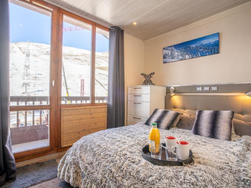 a bedroom with a bed with a view of a mountain at Apartment Rond Point des Pistes - Val Claret-17 by Interhome in Tignes
