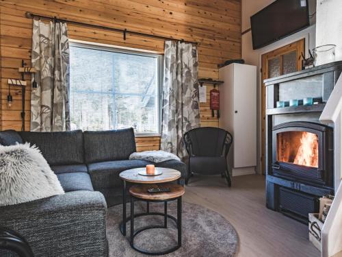 a living room with a couch and a fireplace at Holiday Home Kätkäläinen 5 e 3 by Interhome in Sirkka