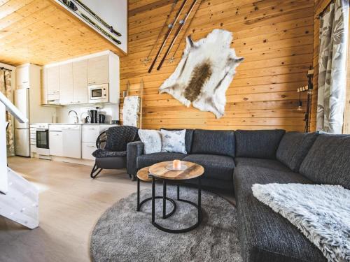 a living room with a couch and a table at Holiday Home Kätkäläinen 5 e 3 by Interhome in Sirkka